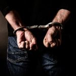 Arrested criminal with handcuffs