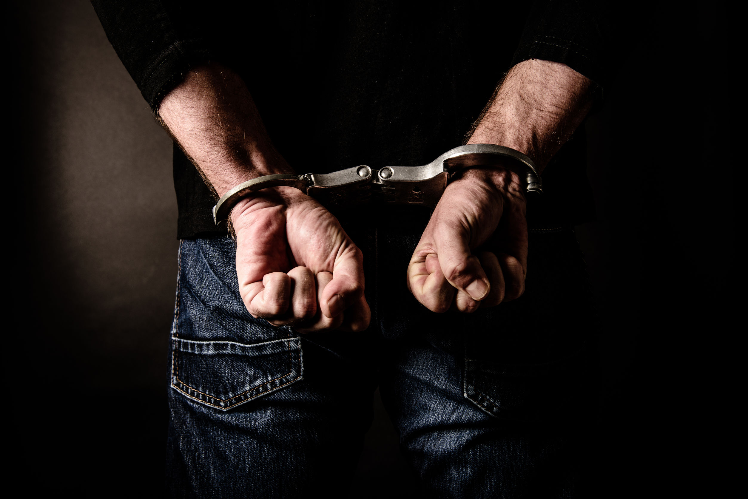 Arrested criminal with handcuffs