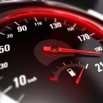 close up of a car speedometer with the needle pointing a high speed, blur effect, conceptual image for excessive speeding or careless driving concept