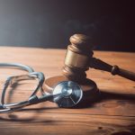 Stethoscope and gavel of the judge on the table